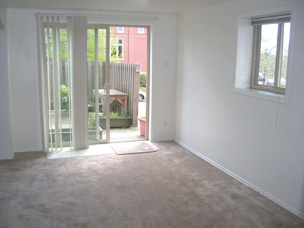 an empty room with a door to a patio
