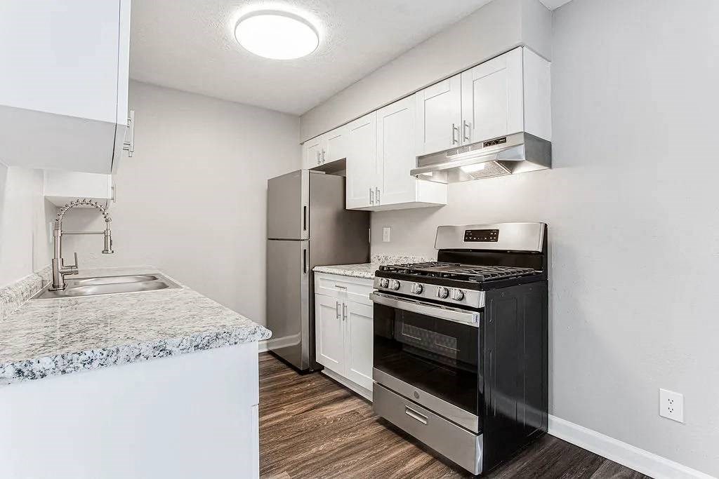 A modern kitchen with a black stove top oven at Chelsea Place Apartments, Lithonia, GA, 30058