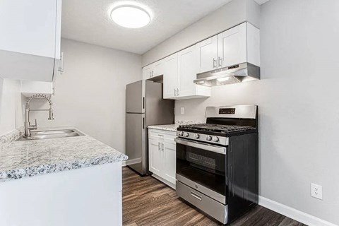 A modern kitchen with a black stove top oven.