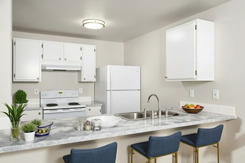 A kitchen with a white refrigerator, a white oven, and a white countertop with a bowl of fruit on it.