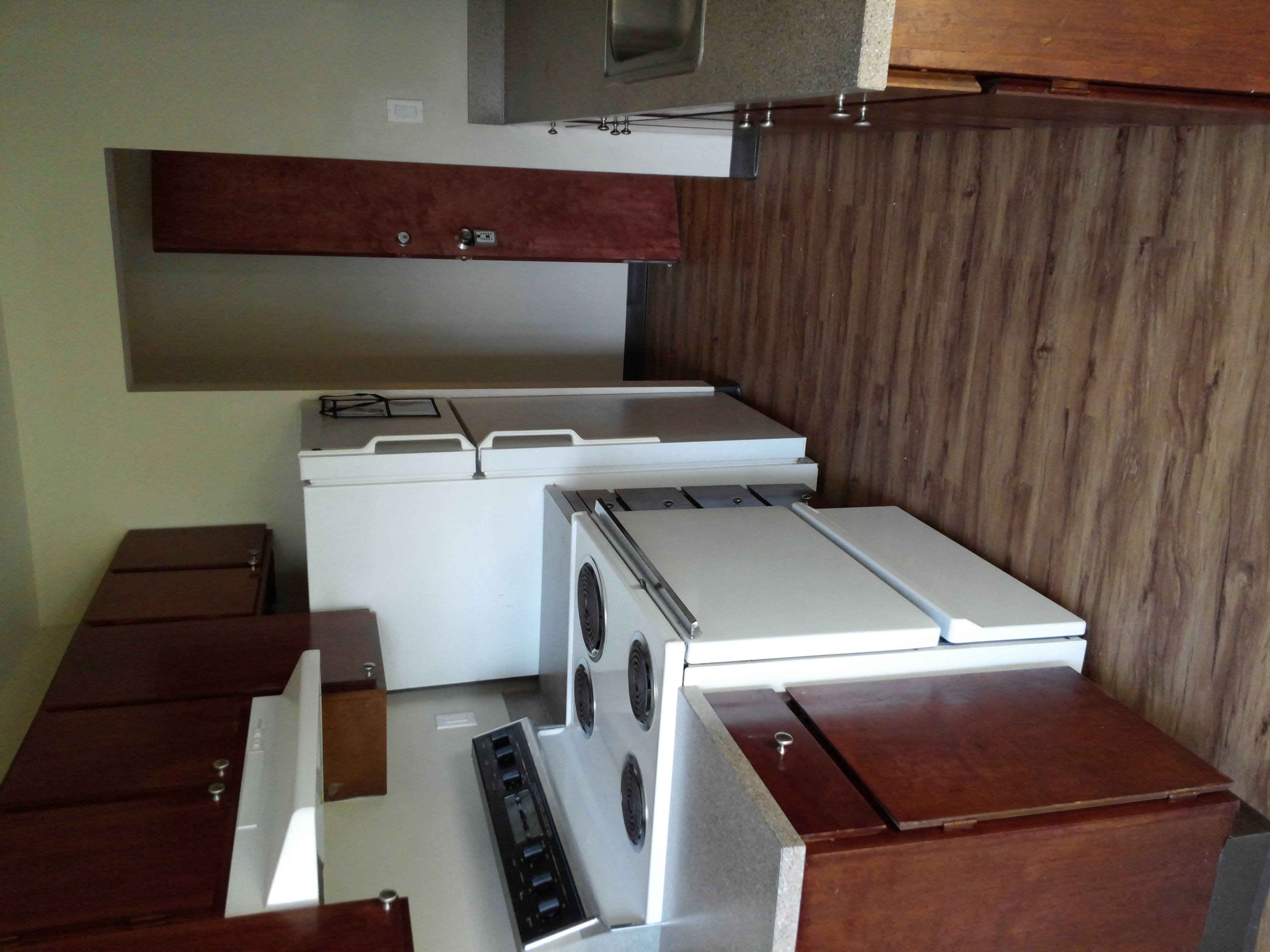 a kitchen with white appliances and wooden cabinets