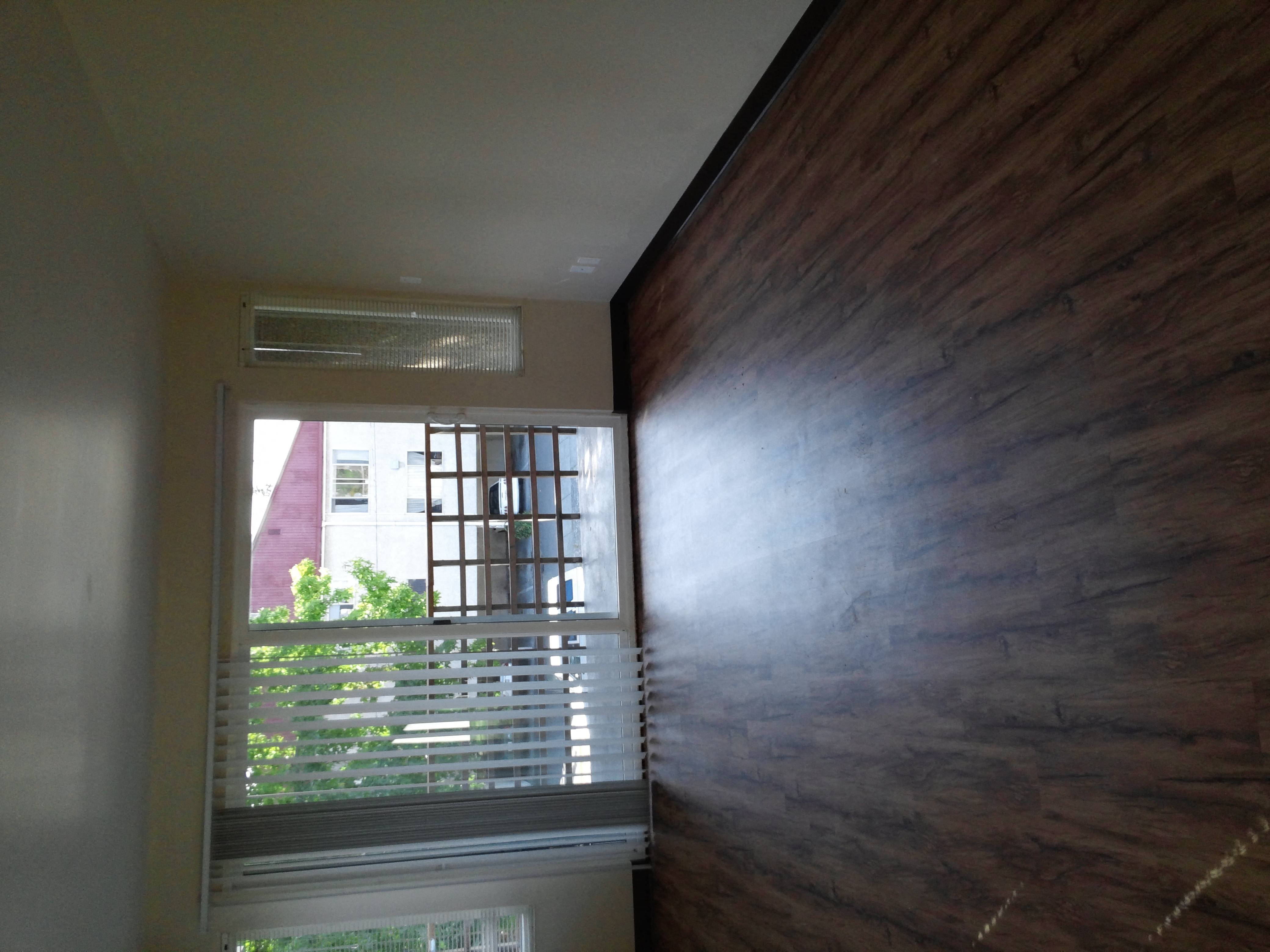 the view from the top of a staircase looking out a window with a wood wall