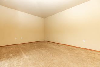 a bedroom with beige carpet and white walls