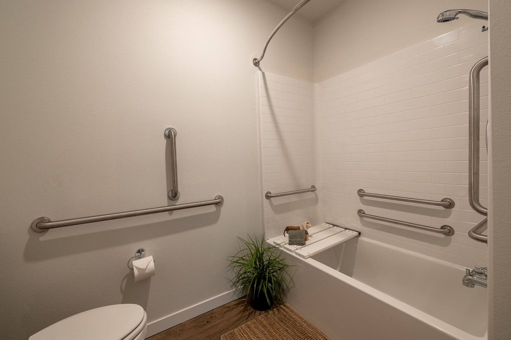 a bathroom with a tub and a toilet and a plant at Sagecrest Apartments, Wenatchee, 98801