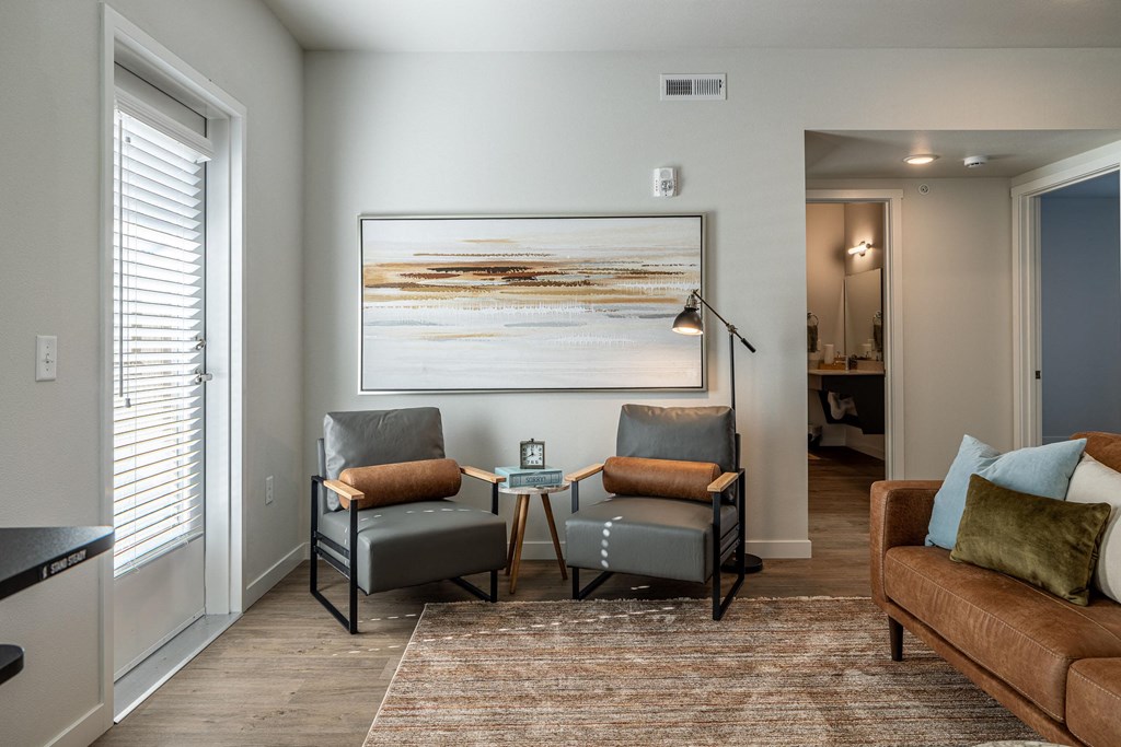 a living room with a couch and chairs and a coffee table at Sagecrest Apartments, Washington, 98801