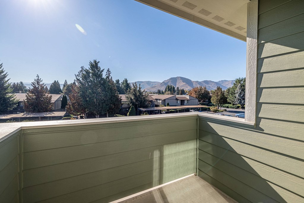 the view from the balcony of a condo with a large window at Sagecrest Apartments, Wenatchee, Washington