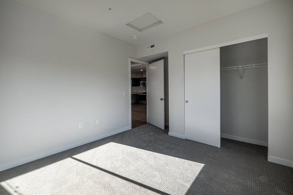 a view of a hallway with white pillars and a gray floor at Sagecrest Apartments, Wenatchee, 98801