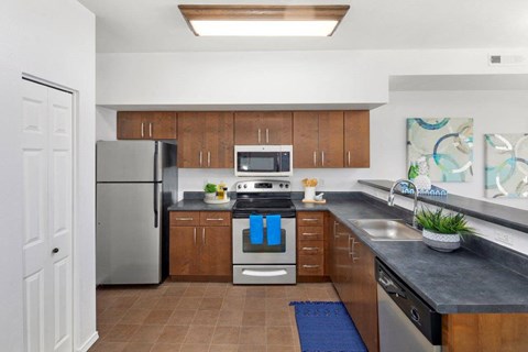 a kitchen with stainless steel appliances and wooden cabinets