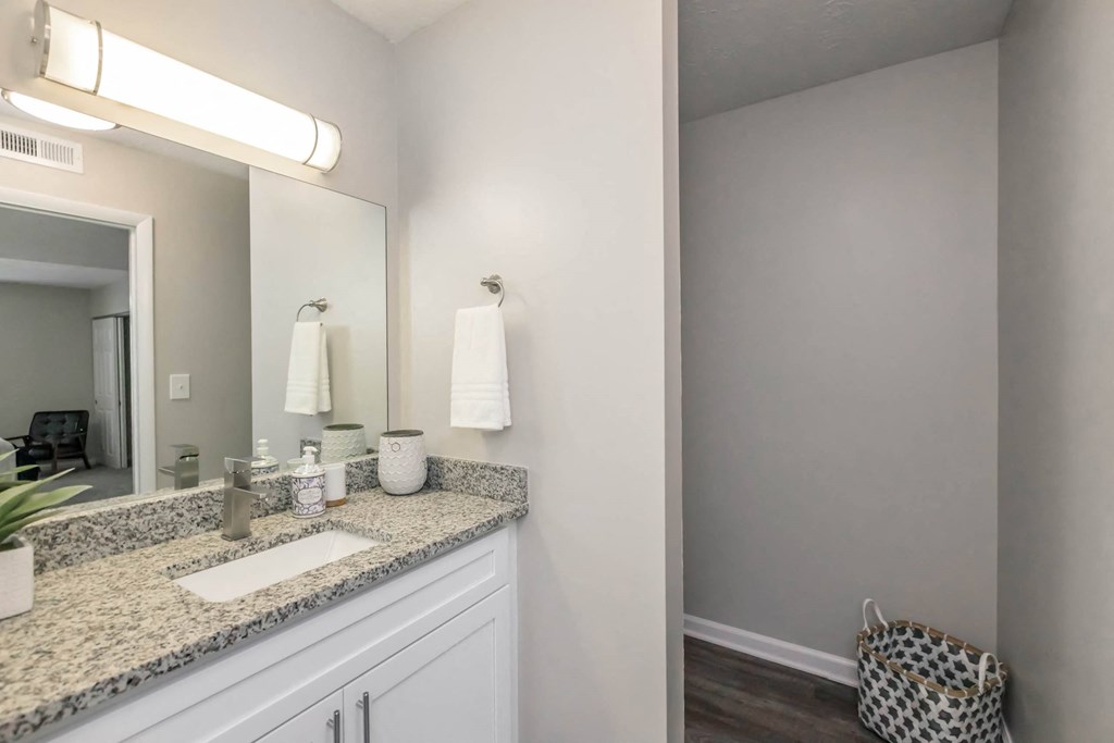 A bathroom with a granite countertop and a large mirror.at 400 Winchester, Georgia, 30339