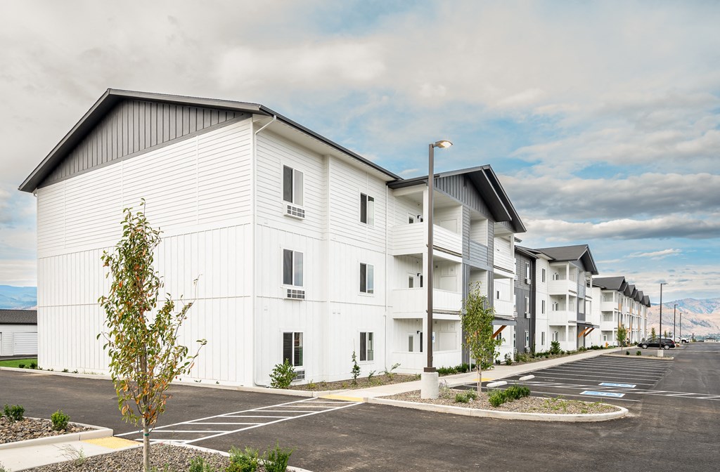 White apartment buildings with a parking lot at Gateway Apartments, East Wenatchee , WA 98802