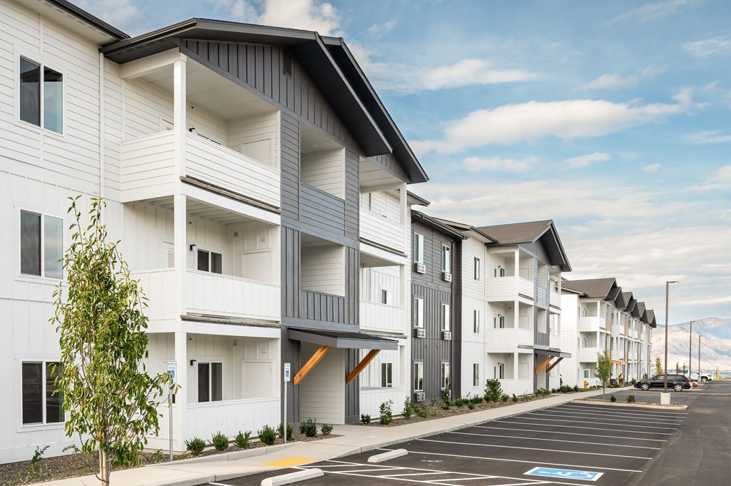 a row of white apartments with balconies and a street at Gateway Apartments, Washington