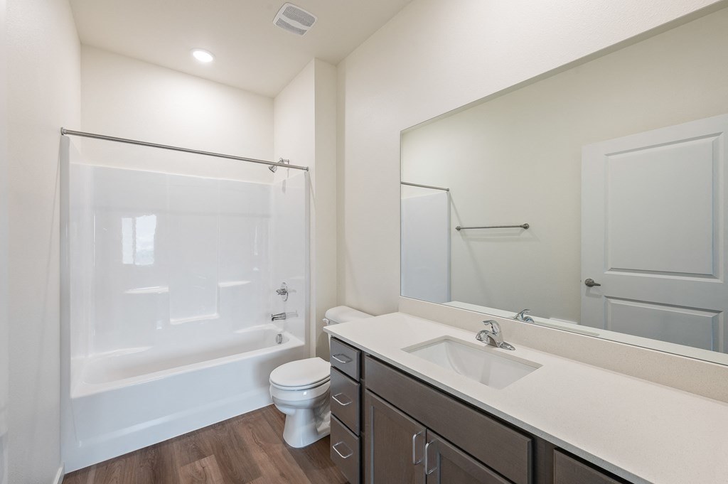 a bathroom with a toilet and a sink and lights at Gateway Apartments, East Wenatchee , WA 98802