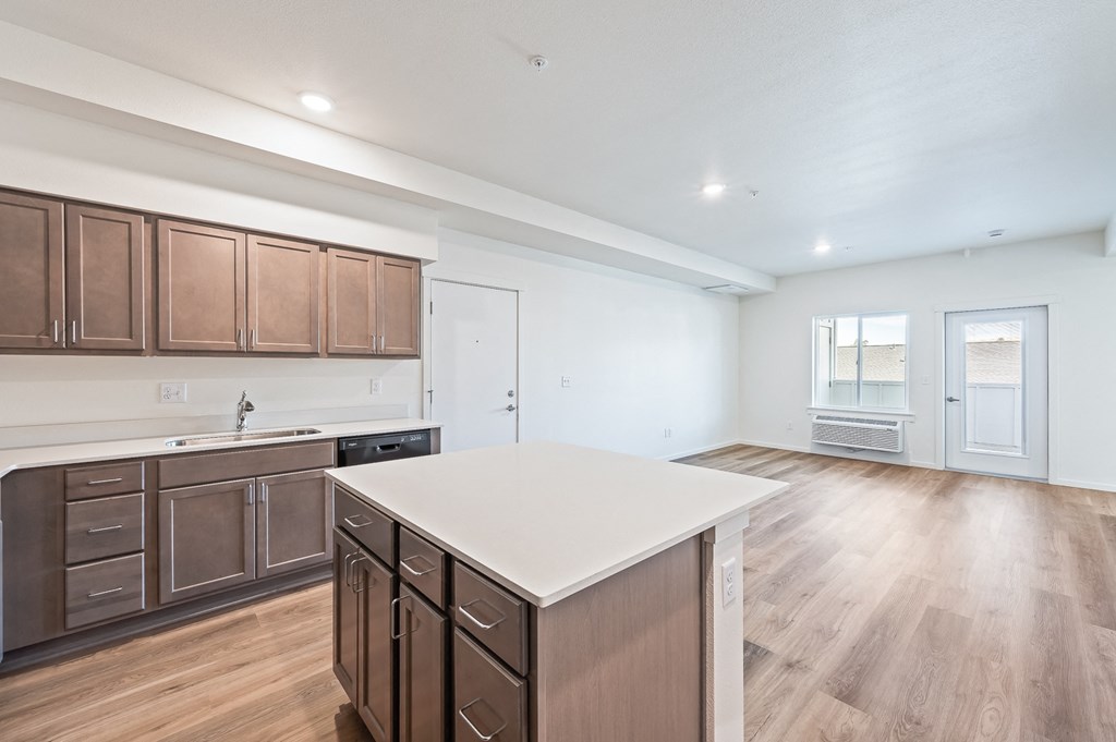 an open kitchen with a white counter top in a new home at Gateway Apartments, Washington