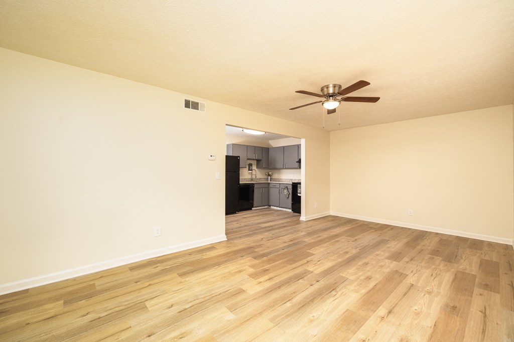 A room with a ceiling fan and wooden flooring at Overlook Club Apartments, Cummings, Georgia