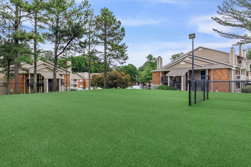 community yard with fence and apartment buildings at The Davis Apartments, Huntsville, AL  