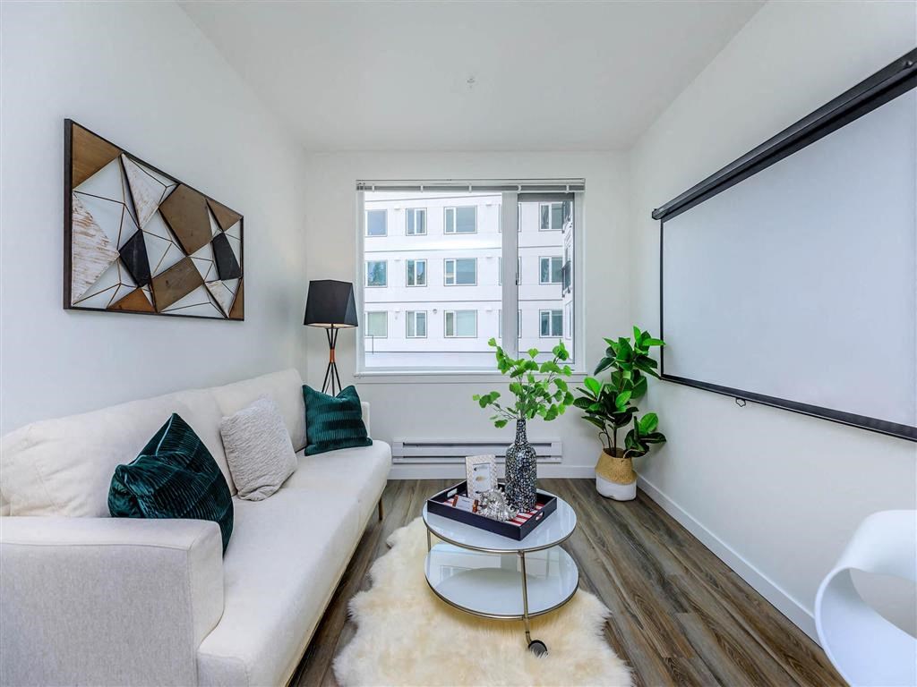 a living room with a white couch and a large window at Jefferson Yards, Tacoma, WA