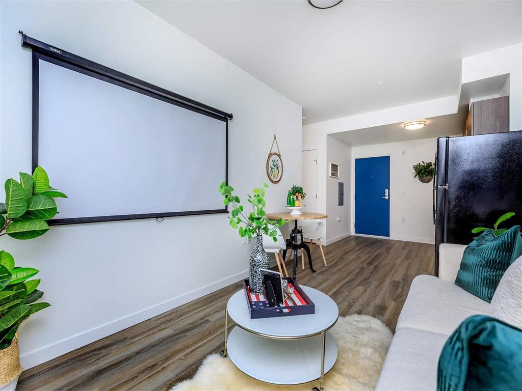 a living room with a white couch and a table with a plant on top of it at Jefferson Yards, Tacoma, WA 98402