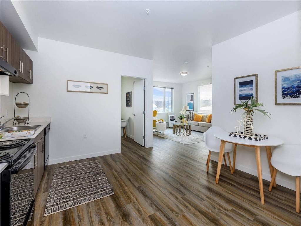 a kitchen and living room with wood floors and white walls at Jefferson Yards, Washington, 98402