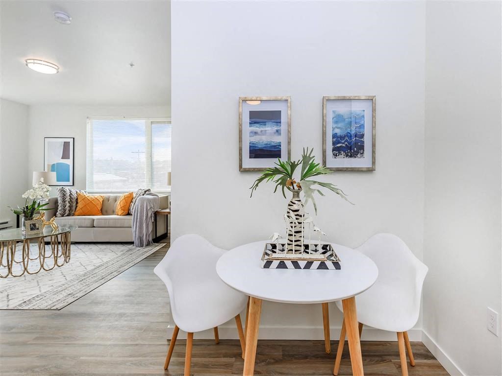 a dining area with a table and chairs and a couch in the background at Jefferson Yards, Tacoma, 98402