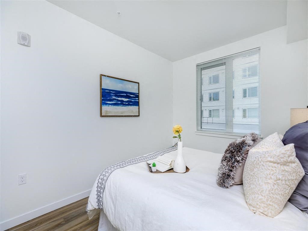 a bedroom with a bed and a large window at Jefferson Yards, Tacoma, WA