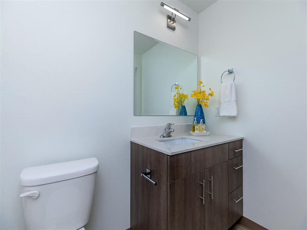 a bathroom with a toilet sink and mirror at Jefferson Yards, Tacoma, 98402
