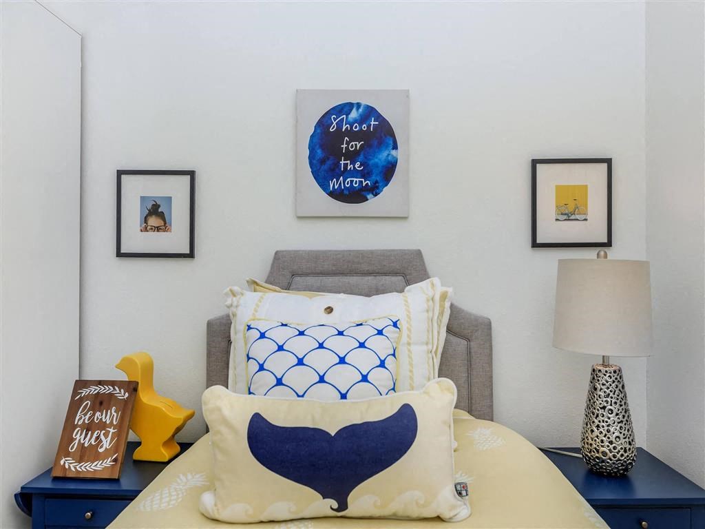 a bedroom with a bed and a nightstand with a lamp on it at Jefferson Yards, Washington, 98402