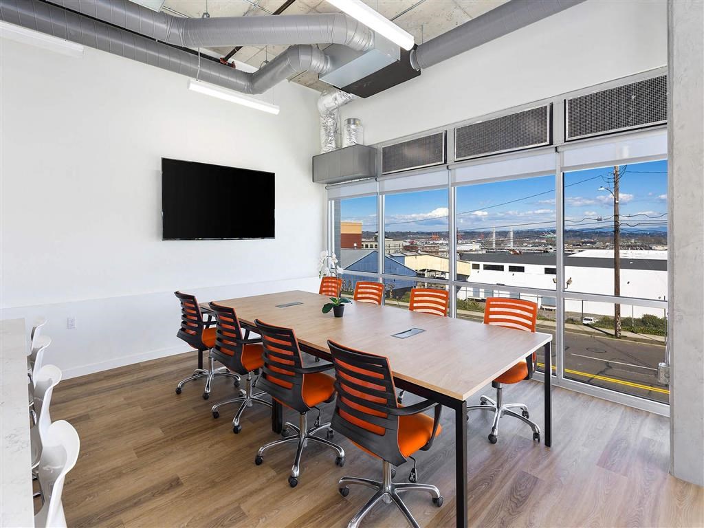 a conference room with a large window and a flat screen tv at Jefferson Yards, Tacoma Washington