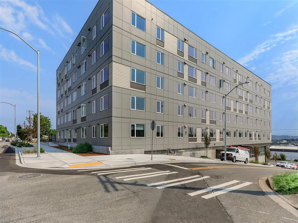 a large gray building with a lot of windows at Jefferson Yards, Tacoma
