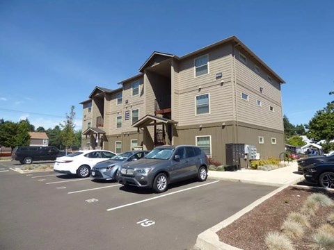 Exterior view of modern apartment building with parking area at Waln Creek Apartments, Salem