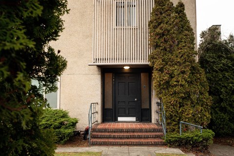 A house with a black door and a small porch.