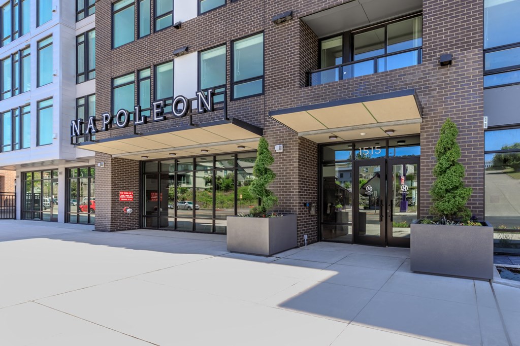 a brick building with a large glass door at Napoleon Apartments, Washington
