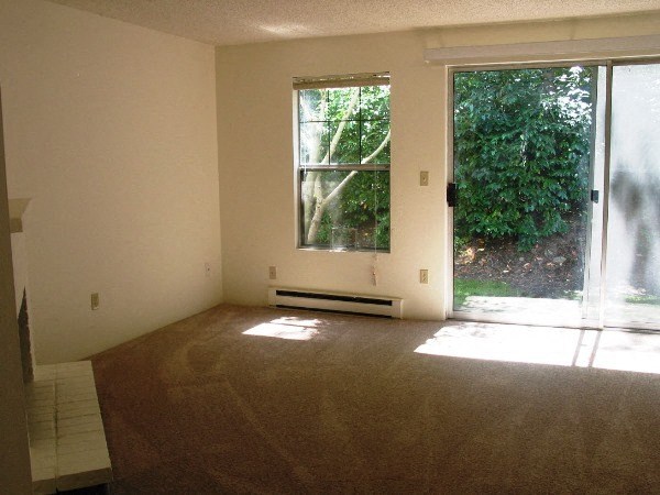an empty living room with a large window