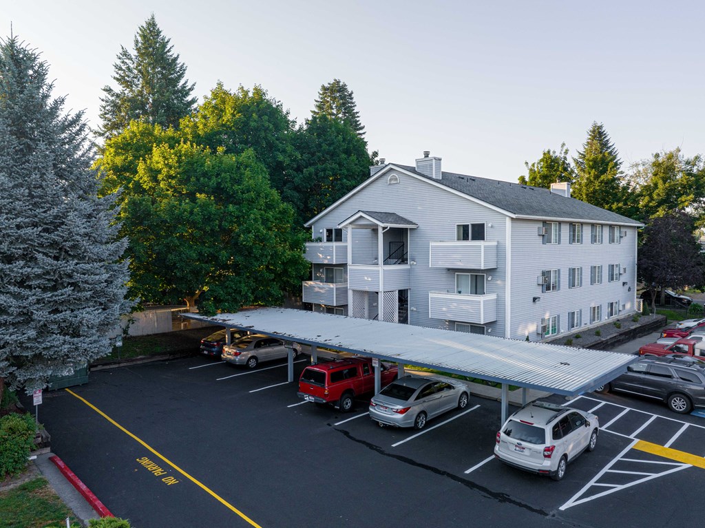 a large white building with a parking lot in front of it  at Ironwood Apartments, Coeur d'Alene, ID