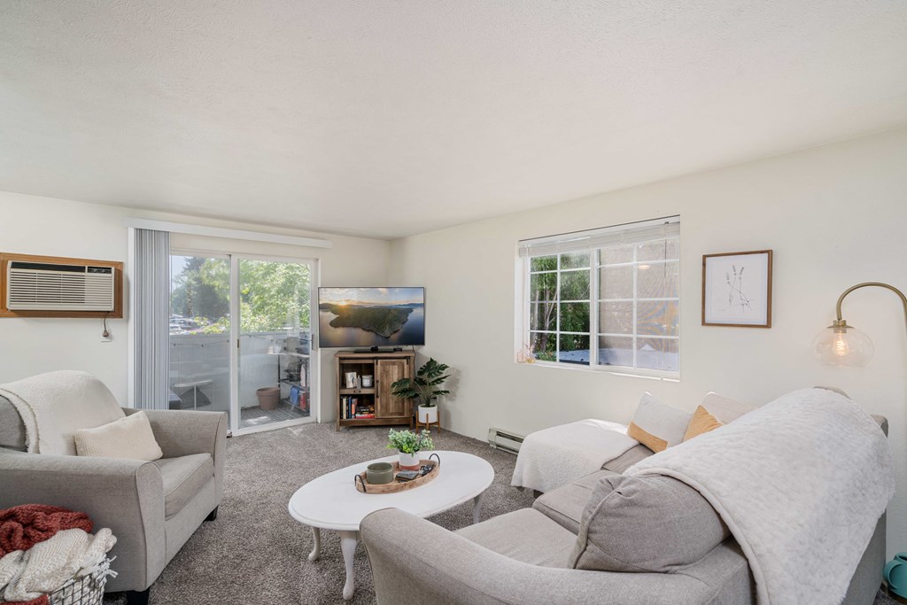 a living room with two couches a coffee table and a tv  at Ironwood Apartments, Coeur d'Alene, ID, 83814