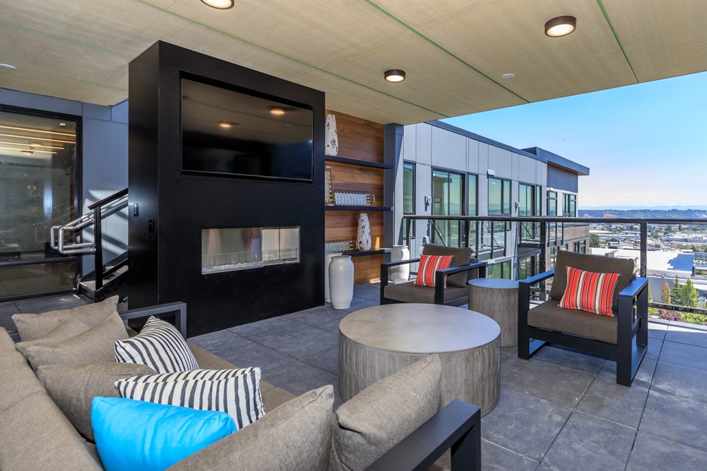 a living room with couches chairs and a fireplace at Napoleon Apartments, Tacoma Washington