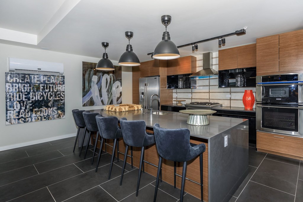 a kitchen with a large center island with a breakfast bar at Napoleon Apartments, Tacoma Washington