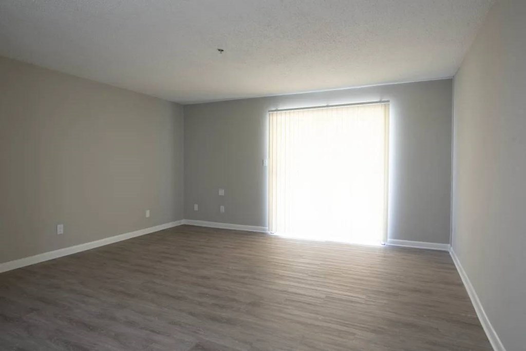 A room with light coming through a window at The Madison Apartments and Townhomes, Lawrenceville, 30044