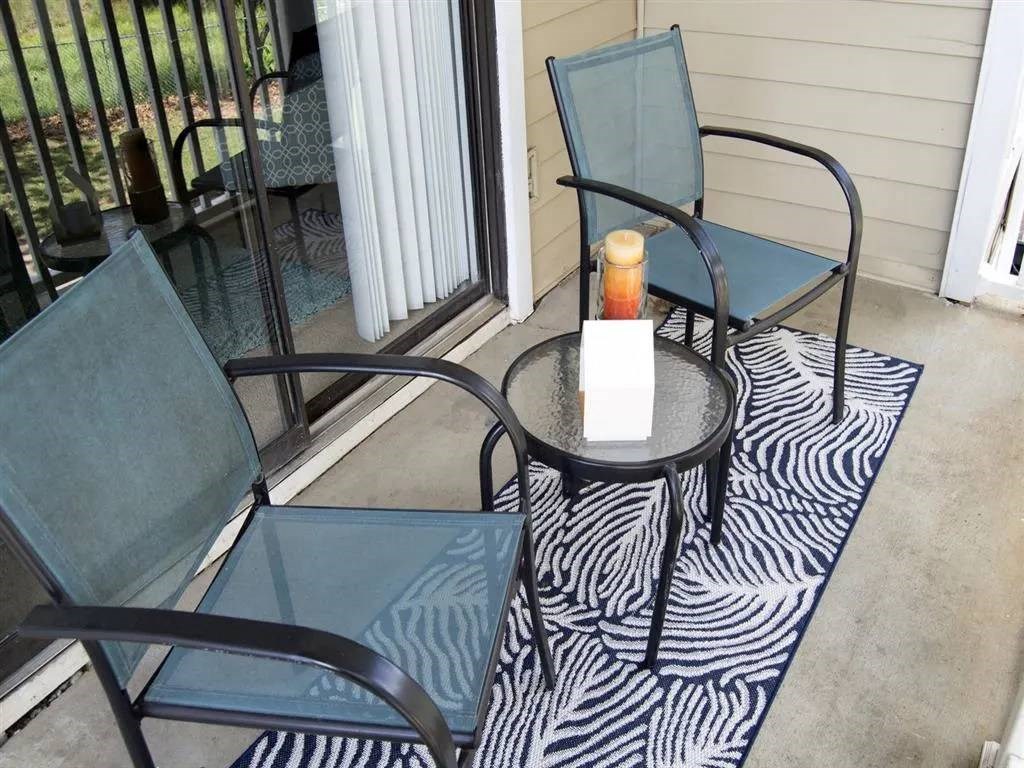 A candle is lit on a table outside at The Madison Apartments and Townhomes, Lawrenceville