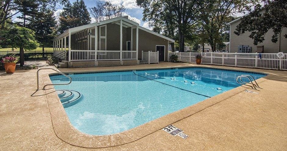 A small pool with a white fence around it at The Madison Apartments and Townhomes, Lawrenceville, 30044