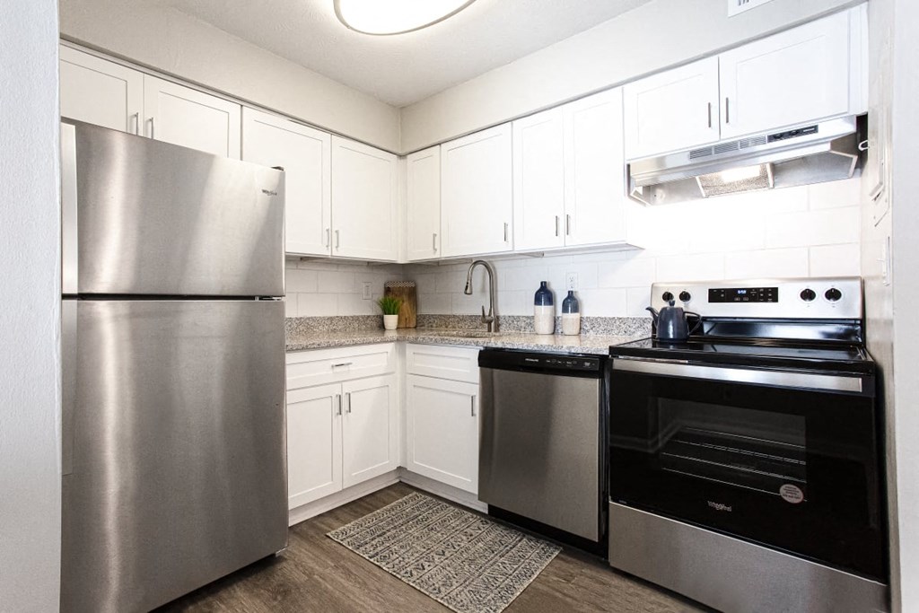 A modern kitchen with a stainless steel refrigerator and oven at Barcelo at East Cobb Apartments, Georgia