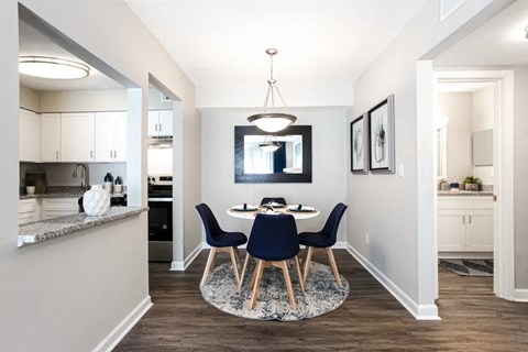 A modern dining room with a round table and chairs at Barcelo at East Cobb Apartments, Marietta, GA