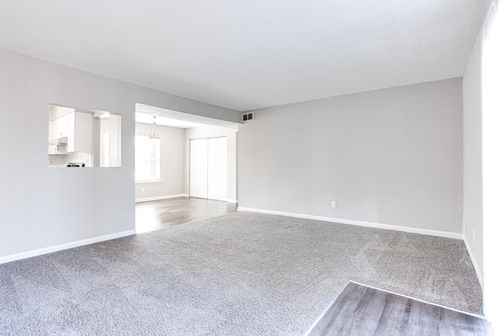 A spacious room with a grey carpet and white walls at Barcelo at East Cobb Apartments, Marietta