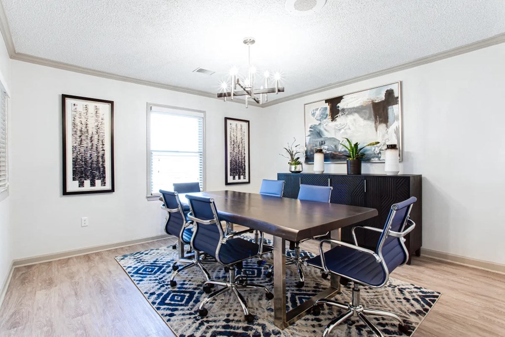 A dining room with a wooden table and blue chairs at Barcelo at East Cobb Apartments, Georgia, 30067