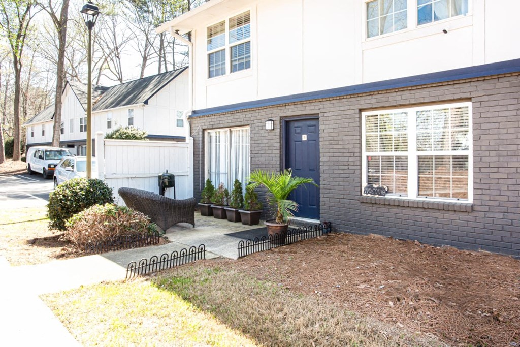 A house with a blue door and a white van parked in front at Barcelo at East Cobb Apartments, GA, 30067