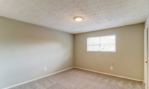 A room with a window and a carpeted floor.at Waverly Manor Townhomes, Georgia, 30071