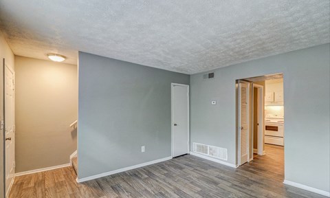 A room with a wooden floor and a white ceiling.at Waverly Manor Townhomes, Norcross, GA