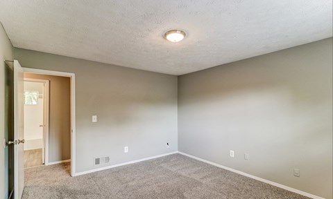 A room with a carpeted floor and a ceiling light.at Waverly Manor Townhomes, Norcross, GA 30071