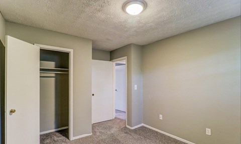 A small, empty room with a white door and a white cabinet.at Waverly Manor Townhomes, Norcross