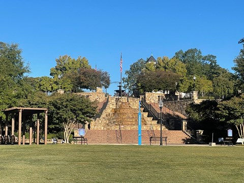 A park with a gazebo, steps, and a flag.at Waverly Manor Townhomes, Norcross, GA 30071