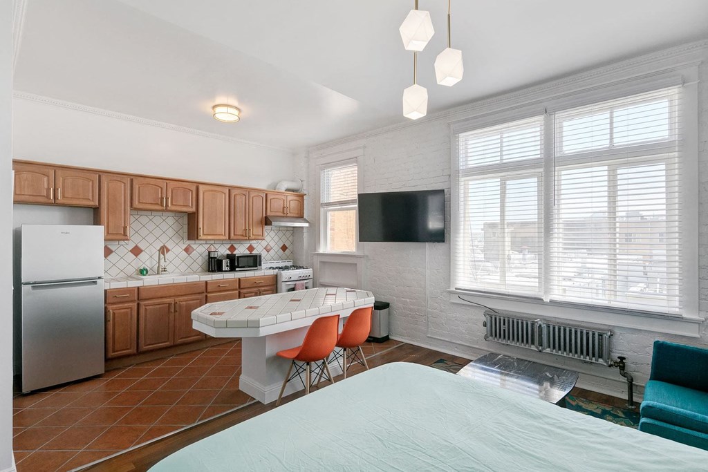 a kitchen with a breakfast bar and a table